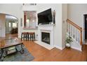 Inviting living room featuring a fireplace, hardwood floors, and an open layout to the kitchen at 1914 Woodsdale Dr, Durham, NC 27703