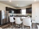 Modern kitchen featuring dark cabinets, granite countertops, and stainless steel appliances at 3521 Strawberry Patch Row, Raleigh, NC 27604