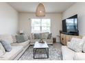 Bright living room with a large window, comfortable seating, and contemporary decor at 3521 Strawberry Patch Row, Raleigh, NC 27604