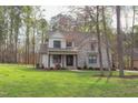 Beautiful two-story home with manicured lawn surrounded by mature trees at 3881 Whisperwood Ct, Youngsville, NC 27596