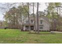 Beautiful two-story home with manicured lawn surrounded by mature trees at 3881 Whisperwood Ct, Youngsville, NC 27596