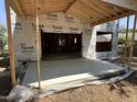 Unfinished patio with exposed rafters, Tyvek HomeWrap, and level access to the yard at 406 Columbia Dr, Raleigh, NC 27604
