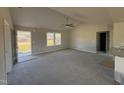 Bright living room featuring vaulted ceilings, neutral carpeting, and large windows, creating an airy atmosphere at 48 Pate Landing Dr, Selma, NC 27576