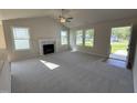 Bright living room featuring a fireplace, vaulted ceilings, and multiple windows providing ample natural light at 49 Heatherglenn Cir, Princeton, NC 27569