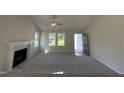 Bright living room featuring a fireplace, vaulted ceilings, and open doorway to front entryway at 49 Heatherglenn Cir, Princeton, NC 27569