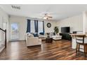 Spacious living room featuring hardwood floors, a ceiling fan, and ample natural light at 518 Oak Forest View Ln, Wake Forest, NC 27587
