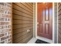 Close-up of the home's rich brown front door and complementary exterior finishes at 521 Rockcastle Dr, Cary, NC 27519
