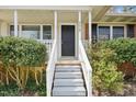 Welcoming front porch and entrance featuring classic columns and a freshly painted door at 5218 Revere Rd, Durham, NC 27713