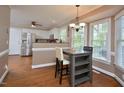 Eat-in kitchen with modern appliances, breakfast bar, stainless steel refrigerator, and hardwood floors at 600 Old Farm Rd Rd, Graham, NC 27253