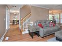 Open living room with hardwood floors and staircase leading upstairs at 600 Old Farm Rd Rd, Graham, NC 27253