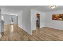 Spacious living room featuring hardwood floors, ample natural light, and freshly painted walls at 613 Holly Thorn, Holly Springs, NC 27540