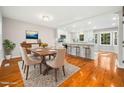 Elegant dining room and kitchen with hardwood floors, white cabinets, and plenty of natural light at 6216 Valley Estates Dr, Raleigh, NC 27612