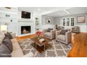Cozy living room with a fireplace, built-in bookshelves, hardwood floors, and comfortable seating at 6216 Valley Estates Dr, Raleigh, NC 27612