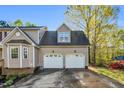 Attached two-car garage, with matching doors at 7221 Messenger Dr, Willow Springs, NC 27592