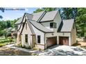 New two-story home featuring stone and horizontal siding with a two-car garage at 7436 Summer Tanager Trl, Raleigh, NC 27614