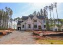 Exterior view of home in construction phase surrounded by tall trees at 7436 Summer Tanager Trl, Raleigh, NC 27614