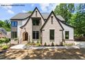 Front exterior showcasing beautiful brickwork, dark trim, and manicured landscaping at 7436 Summer Tanager Trl, Raleigh, NC 27614