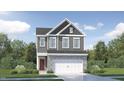 Two-story home with gray siding, black roof, and two-car garage featuring stone facade on a landscaped lot at 752 Swim Cave Ln, Wendell, NC 27591