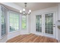 Cozy dining area with bay window and French doors providing ample natural light and backyard access at 8000 Elderson Ln, Raleigh, NC 27612