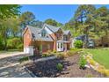 Spacious brick home with a well-maintained lawn and a long driveway leading to the attached garage at 8059 Hogan Dr, Wake Forest, NC 27587
