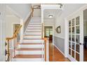 Elegant foyer with hardwood floors, a staircase, and neutral-toned walls creating a bright and inviting atmosphere at 8059 Hogan Dr, Wake Forest, NC 27587