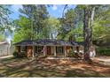 Charming single-story brick home with a manicured lawn and mature trees at 812 Northclift Dr, Raleigh, NC 27609