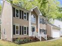 Charming home with manicured lawn and mature trees provides an inviting exterior at 8921 Walking Stick Trl, Raleigh, NC 27615