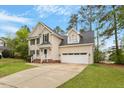Charming two-story home featuring an attached two-car garage and well-maintained landscaping at 903 Norwood Lane Ln, Apex, NC 27502