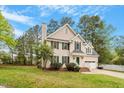 Charming two-story home with a well-manicured lawn and inviting curb appeal at 903 Norwood Lane Ln, Apex, NC 27502