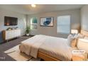 Serene primary bedroom with calming colors, large windows, and a cozy rug at 91 Paige Stone Way, Angier, NC 27501