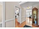 Hallway featuring hardwood floors that lead to the kitchen and other rooms in the house at 9204 Cub Trl, Raleigh, NC 27615