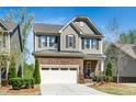 Beautiful home with stone and siding, complemented by a well-maintained lawn and a convenient two-car garage at 936 Regency Cottage Pl, Cary, NC 27518
