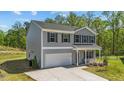 Two story home shows a wide driveway, front yard and trees in the background at 95 Shady Creek Trl, Garner, NC 27529