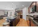 Contemporary kitchen boasts a center island, stainless steel appliances, and hardwood floors at 95 Shady Creek Trl, Garner, NC 27529
