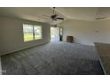 Bright living room with new carpet, vaulted ceiling, and a view to the front entrance at 99 Pate Landing Dr, Selma, NC 27576