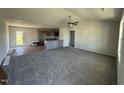Spacious living room flows to the kitchen, featuring new carpet and ample natural light at 99 Pate Landing Dr, Selma, NC 27576