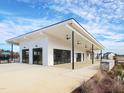 Community center featuring a spacious covered patio, modern architecture, and elegant black trim at 1017 Channel Drop Lp, Zebulon, NC 27597