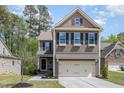 Inviting two-story home featuring a well-manicured lawn and attached two-car garage at 104 Lowe Wood Ct, Durham, NC 27703