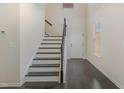 Bright foyer with hardwood floors, staircase, and white trim creating a welcoming entrance at 104 Lowe Wood Ct, Durham, NC 27703