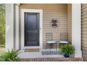 Cozy front porch with seating and charming decor, inviting you to relax and enjoy the outdoors at 104 Lowe Wood Ct, Durham, NC 27703