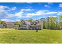 Landscaped front yard leading up to a gray two-story home, creating a welcoming curb appeal at 1077 Williams-White Rd, Zebulon, NC 27597