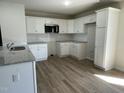 Well-lit kitchen boasts modern appliances, white cabinetry, subway tile backsplash, and ample counter space at 108 Pate Landing Dr, Selma, NC 27576