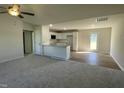 Open-concept living space features a modern kitchen with white cabinets and a spacious area perfect for entertaining at 108 Pate Landing Dr, Selma, NC 27576