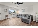 Inviting living room featuring hardwood floors, a comfortable gray sofa, and large windows for natural light at 1110 Bent Willow Dr, Durham, NC 27704