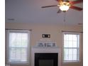 Living room with neutral walls, white trim, a fireplace, and abundant natural light at 1215 Agile Dr, Knightdale, NC 27545