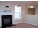 Cozy living room showcasing a fireplace with a white mantel and adjacent built-in shelving at 1215 Agile Dr, Knightdale, NC 27545