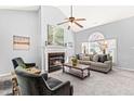 Inviting living room featuring a fireplace, large windows, and stylish furnishings for relaxing and entertaining at 12325 Inglehurst Dr, Raleigh, NC 27613