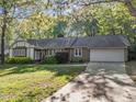 Lovely ranch-style home with an attached garage, manicured lawn, and beautiful landscaping at 1304 Deboy St, Raleigh, NC 27606
