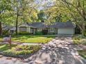 Attractive home with a well-kept lawn, mature trees, and a convenient two-car garage at 1304 Deboy St, Raleigh, NC 27606