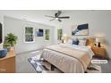 Bright main bedroom with large windows, ceiling fan, and neutral decor at 14 W Bridlewood Trl, Durham, NC 27713